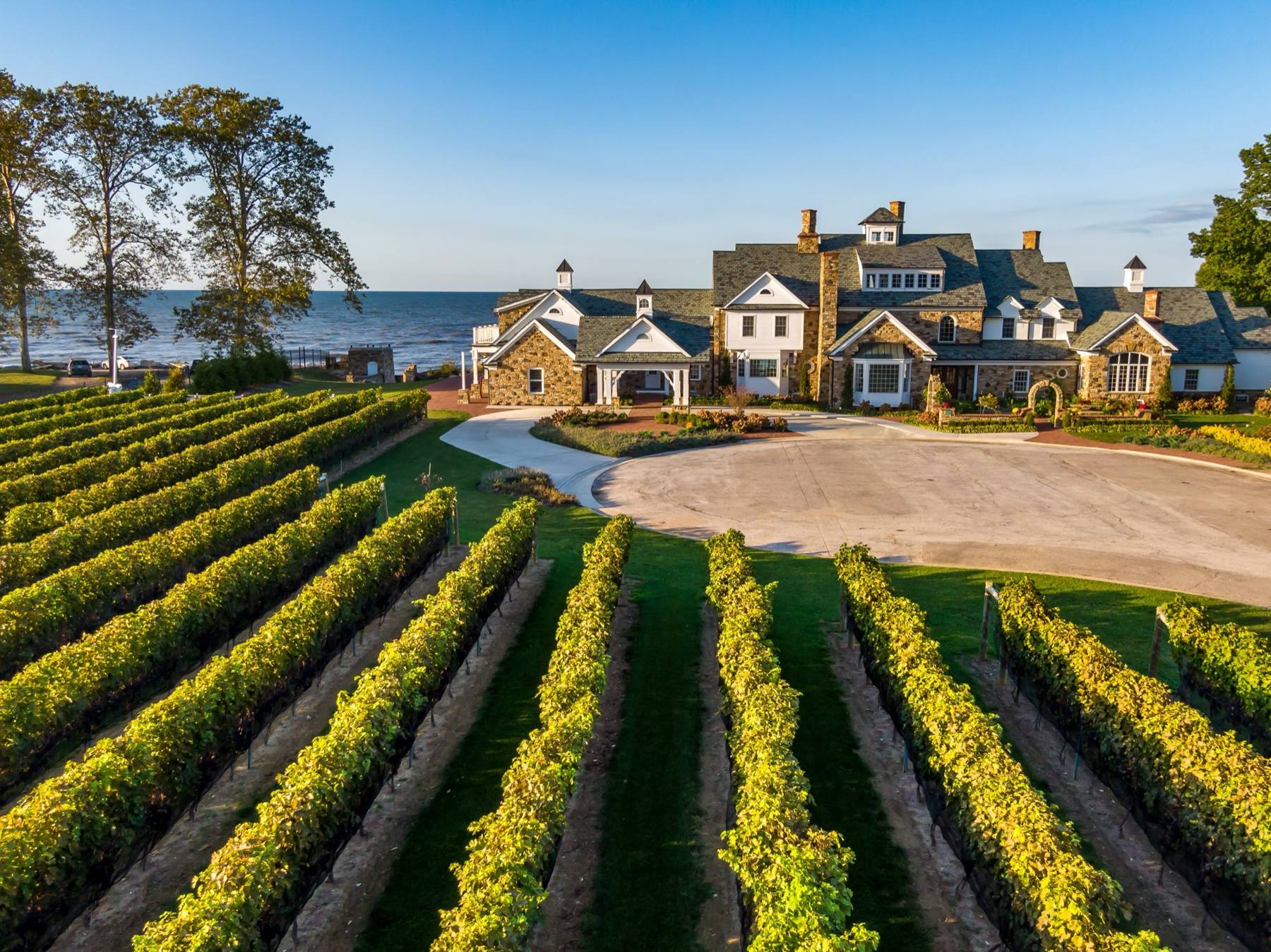 The mansion at Vincent William above the estate vineyard, with Lake Erie behind it